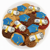 Decorative cookies shaped like graduation caps and scrolls on a white plate.