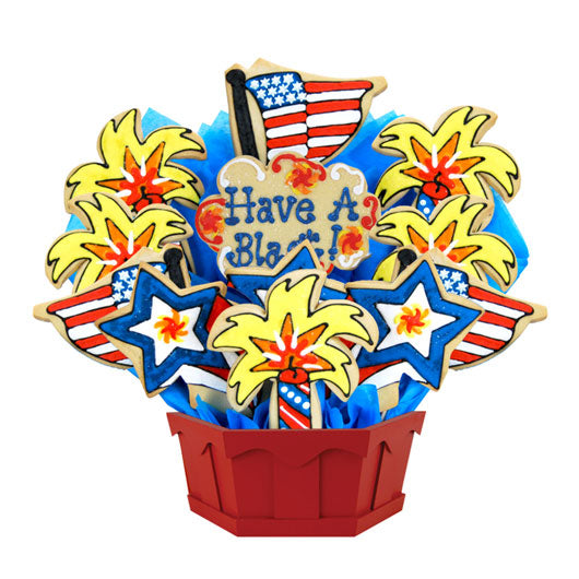 Fourth of July cookie bouquet with stars, fireworks, American flag, and 'Have a Blast!' sign.