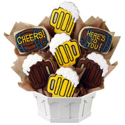 Cookie bouquet with decorated beer mug and barrel cookies, some with 'Cheers!' and 'Here's to You!' messages