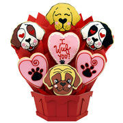 Dog-themed cookie bouquet with heart and paw print decorated cookies in a red container