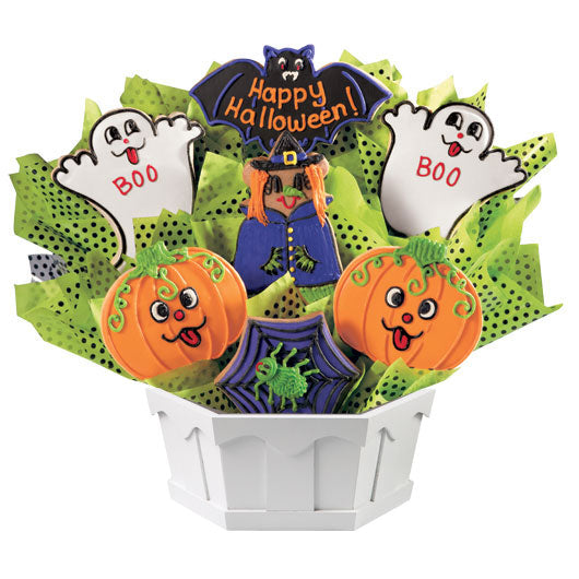 Halloween cookie bouquet with pumpkin, ghost, bat, and witch cookies in a white container