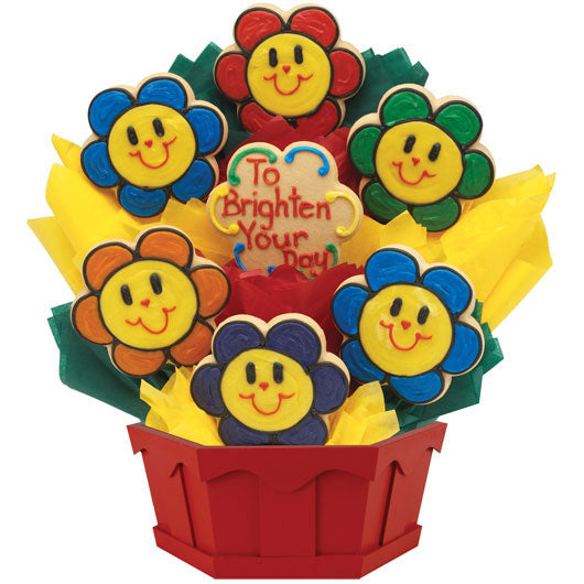 Flower-shaped smiley face cookie bouquet in a red basket with cheerful icing colors