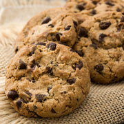 Fresh chocolate chip cookies on rustic burlap, gourmet baked gift delivery