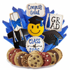 Graduation-themed cookie arrangement with cookies shaped like a smiley face, graduation hats, and 'Congrats Grad' signs on a white background.