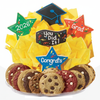 Graduation-themed cookie platter with decorative stars and a 'You Did It!' sign, surrounded by yellow tissue paper.