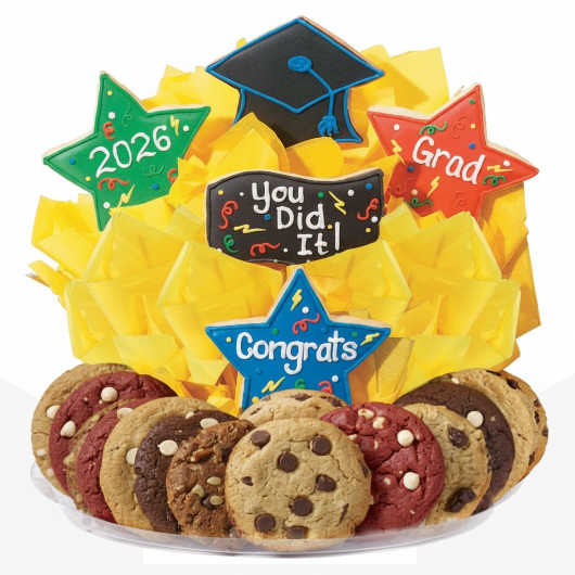 Graduation-themed cookie platter with decorative stars and a 'You Did It!' sign, surrounded by yellow tissue paper.