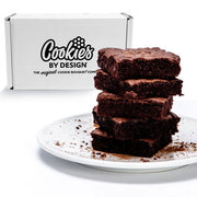 Stack of rich chocolate brownies on a plate with gift box in background, gourmet dessert gift