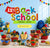 A colorful Back to School themed promotional display with a large '15% OFF Back to School PROMO - BTS1' sign, a yellow 'SHOP NOW' button, and assorted school-themed treats, cookies, pencils, books, a globe, and a backpack arranged on a table against a light blue wall.