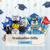 Graduation-themed decorations with 'Congrats Grad' and 'GRAD' signs on a light blue background.