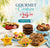 A promotional display for gourmet cookies featuring assorted chocolate chip cookies, layered cookies, colorful macaroon cookies, and decorated cookies on plates and stands. Large text at the top reads 'Gourmet Cookies Starting at $29.