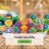 Colorful 'Thank You' gift items in a box with a blurred background and 'Shop Now' button.